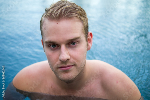 Young handsome shirtless man with blond hair in the swimming pool © Ranta Images