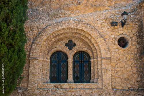 Window with vitrage in old church in rock in Spain.