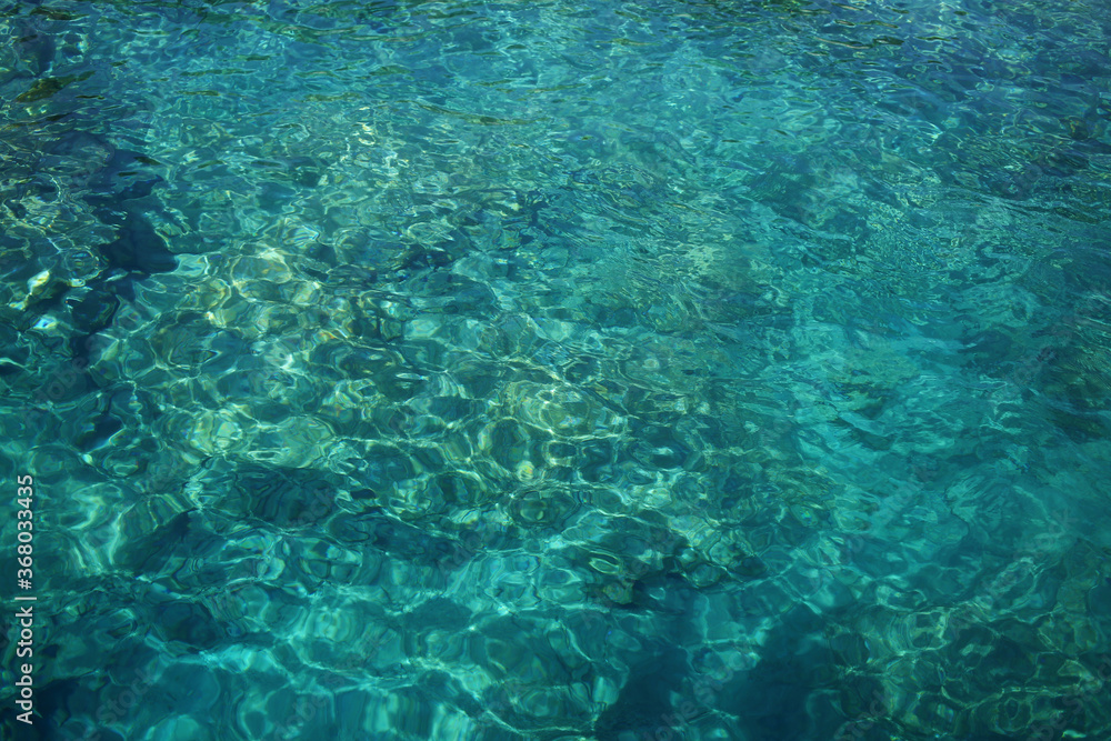 Fototapeta premium The surface of the clean and clear water of the Mediterranean.
