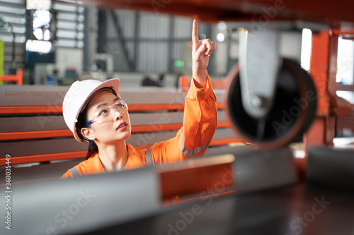 Female Factory Engineer Counting the workpiece. photo
