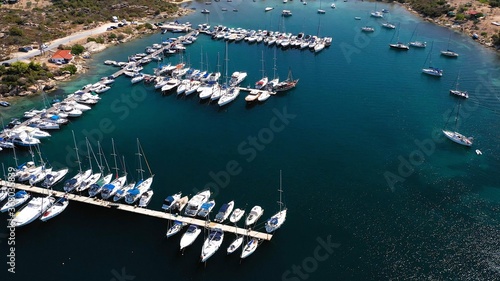 Obraz na płótnie Aerial view of a blue ocean near a harbor shore at daytime