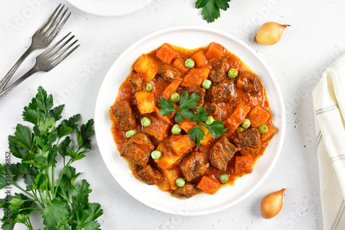 Homemade beef stew with potatoes and carrots in tomato sauce