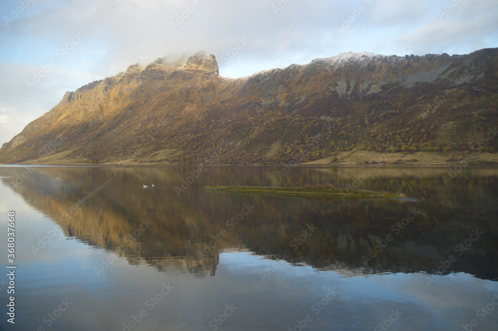 Autumn colors and reflections in the Norwegian mountains of the Lofoten Fjords in Norway