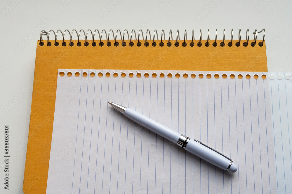 White pen on blank page from spiral notebook. Education background. White pen on blank page from spiral notebook. Education background.