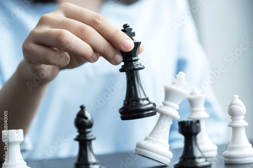 hand move chess with strategy and tactic to win enemy, play battle on board game, business opportunity  competition strategic challenge concept