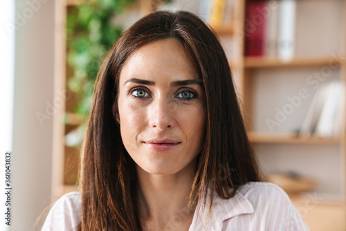 Business woman looking at camera in office