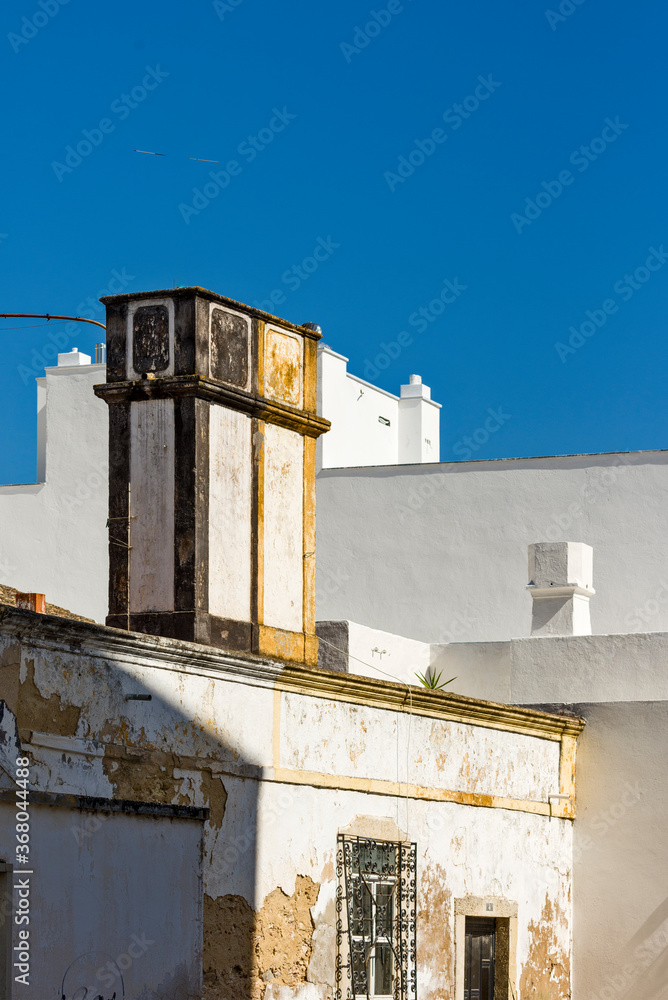 traditional old chimney on a terrace of a house in Faro, Algarve, Portugal