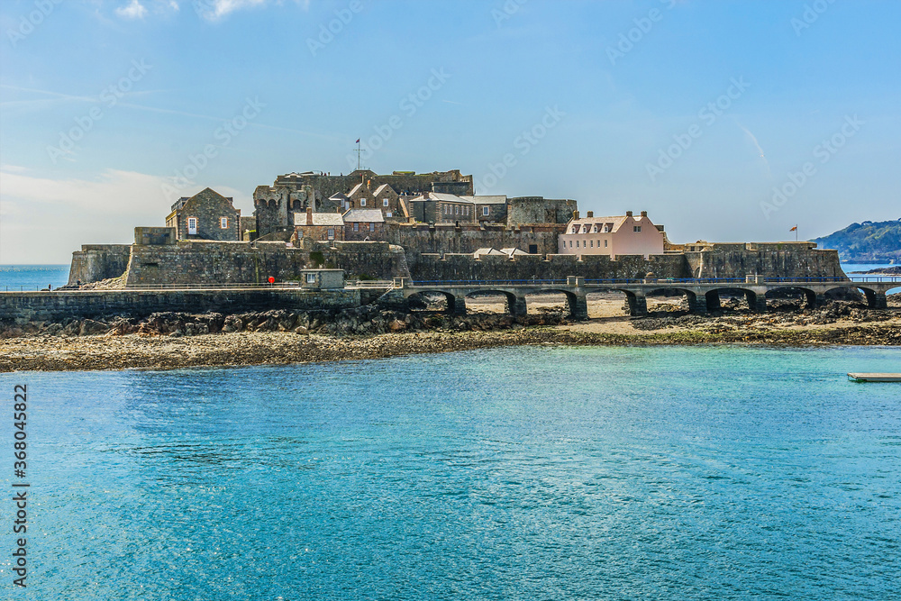 View from sea of Castle Cornet. Castle Cornet has guarded Saint Peter Port for 800 years. Saint Peter Port - capital of Guernsey, British Crown dependency in English Channel off coast of Normandy.