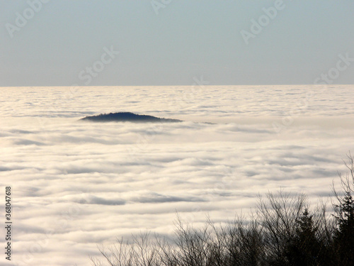 White clouds with a top a a hill in Matra mountains. View from peak Kekesteto, highest point in Hungary.