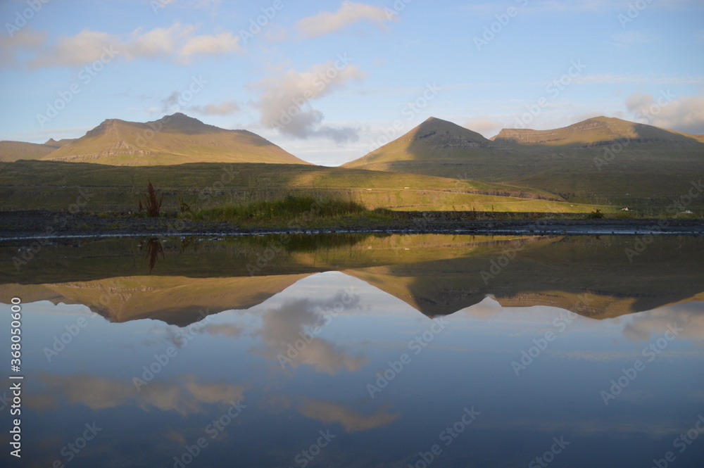 The dramatic and charming nature and mountains on the Faroe Islands The dramatic and charming nature and mountains on the Faroe Islands
