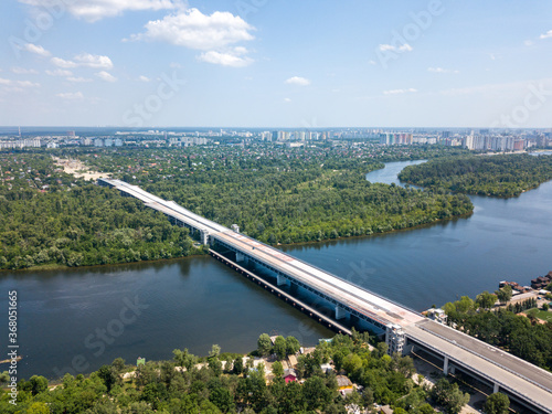 Construction of a bridge across the Dnieper river in Kiev. Aerial drone view.