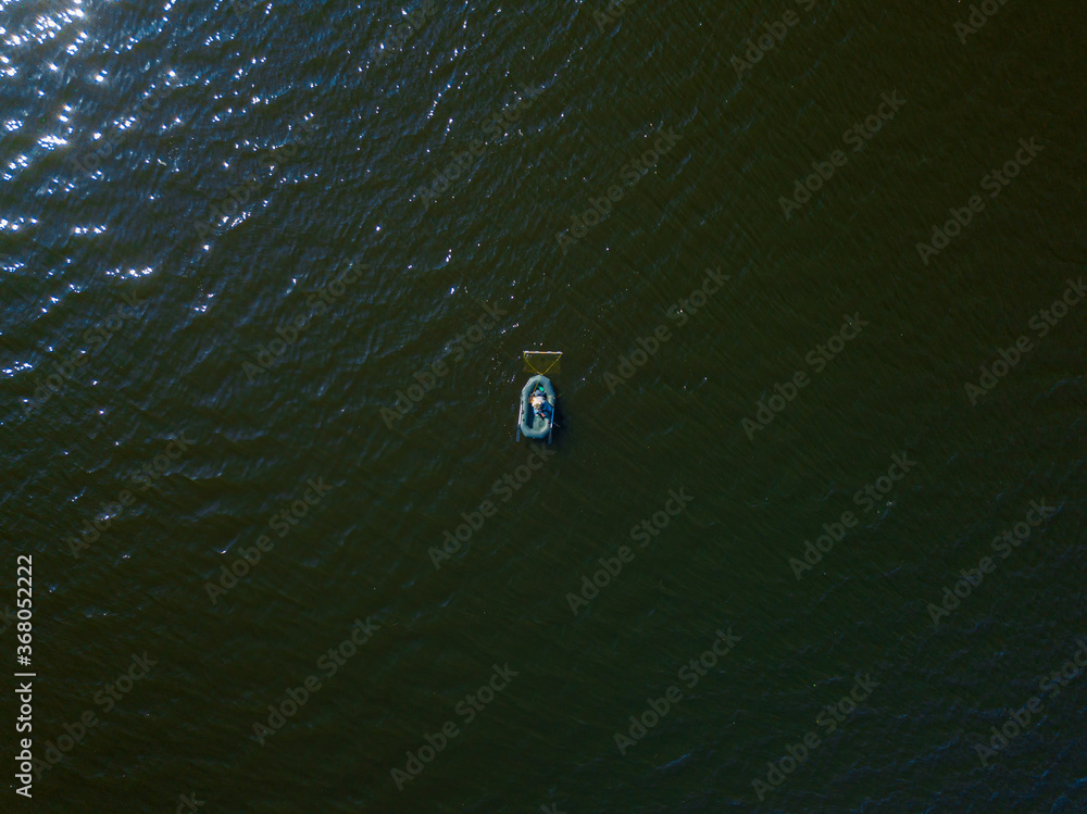 Aerila drone top view. Fishing boat on the water. Aerila drone top view. Fishing boat on the water.