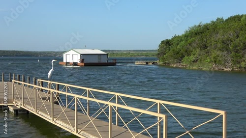 Beautiful landscape at  Possum Kingdom Lake. View of a boat pier with a large  bird sitting on the railing,