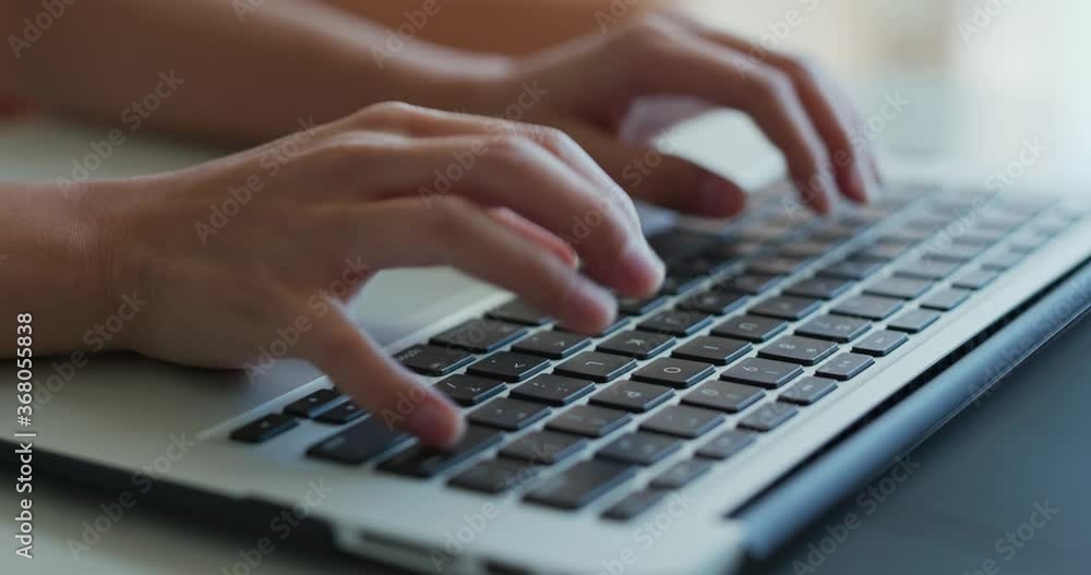 Type on laptop computer at home