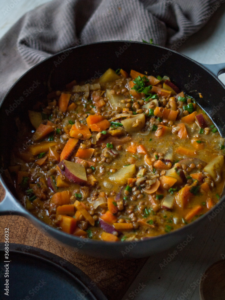Rustic carrot and lentil curry in pot