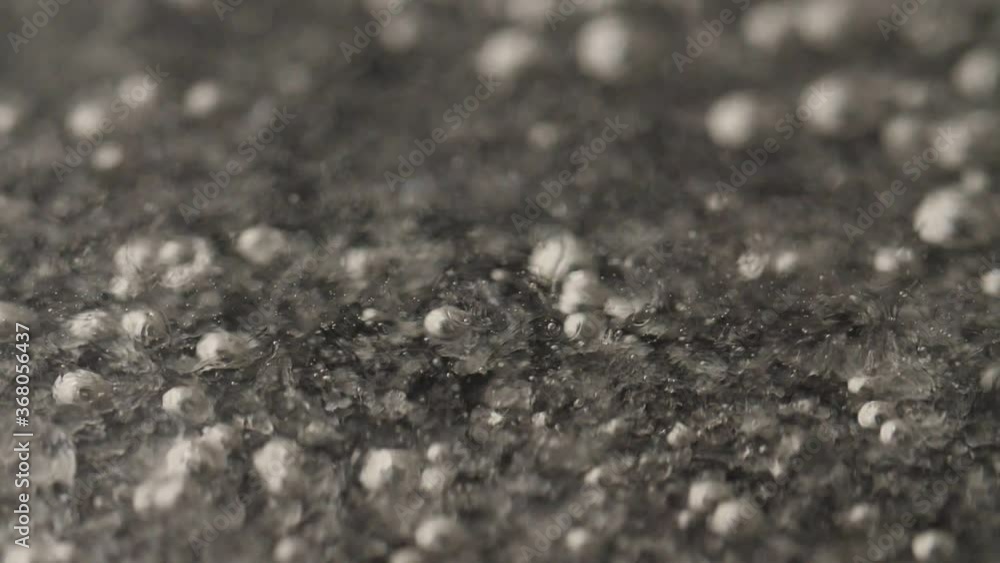 A thick, clear, slowly boiling liquid. Macro shot. A thick, clear, slowly boiling liquid. Macro shot.
