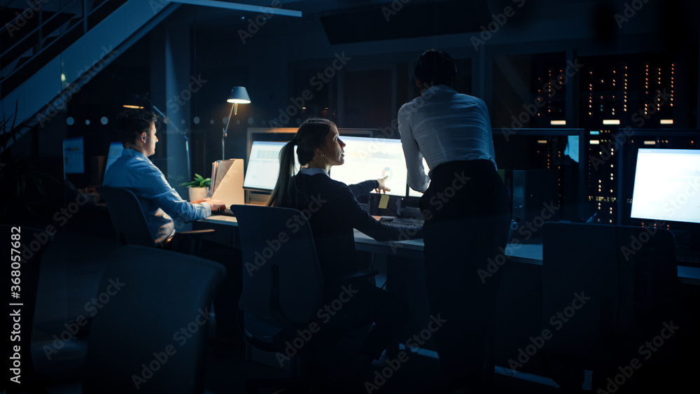 Late at Night In Modern Office: Diverse Team of Successful Businessmen and Businesswomen Work on Desktop Computers, Having Discussion, Finding Problem Solutions, Finishing Project Late at Night In Modern Office: Diverse Team of Successful Businessmen and Businesswomen Work on Desktop Computers, Having Discussion, Finding Problem Solutions, Finishing Project