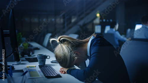 Vászonkép In the Office at Night Overworked Tired Female Office Worker Fell Asleep on Her Hands