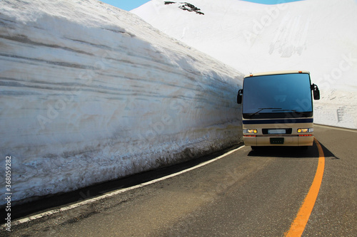 japan bus run along snow wall in Tateyama Kurobe Alpine Route photo