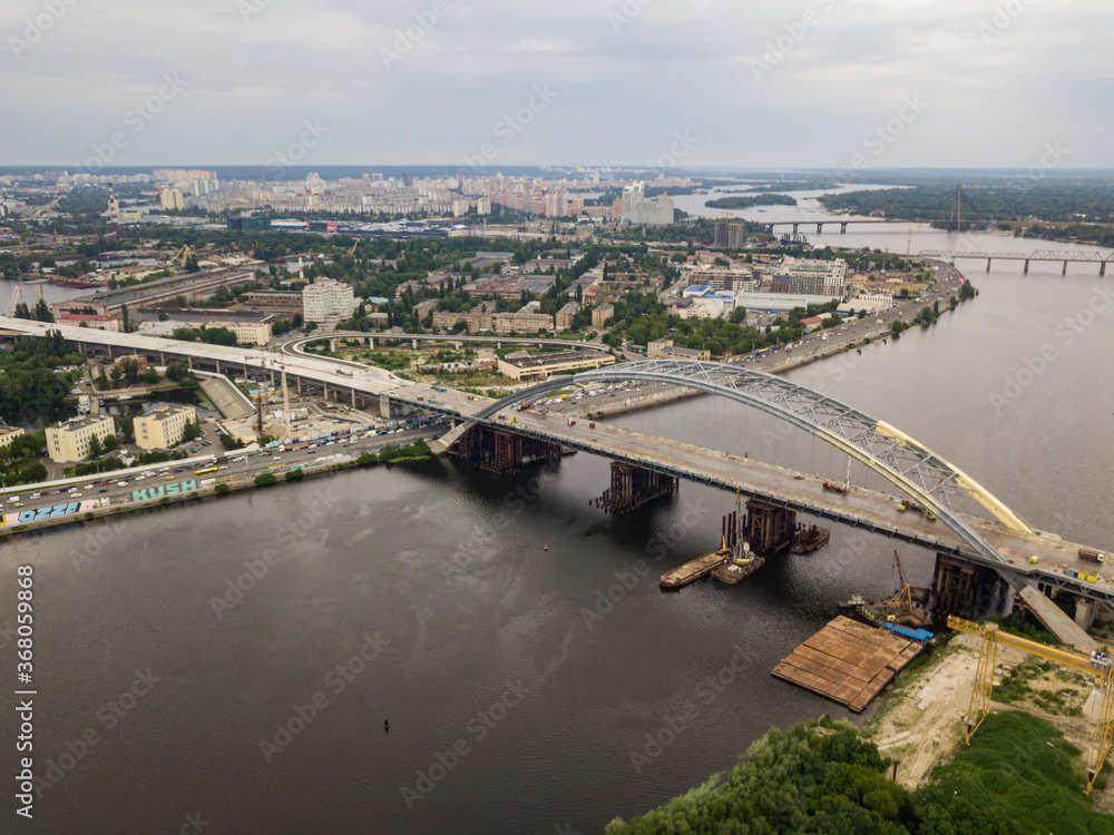 Obraz premium Construction of a bridge across the Dnieper river in Kiev. Aerial drone view.