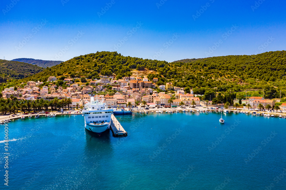 VIS, VIS ISLAND, CROATIA Aerial view of the city and port with passenger ferry which connects Split and Vis