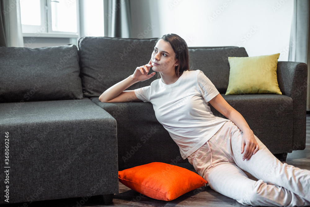 Young woman pretty relaxing on couch in living room Young woman pretty relaxing on couch in living room