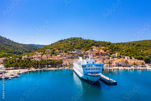 Fototapeta Naklejka Na Ścianę i Meble -  VIS, VIS ISLAND, CROATIA Aerial view of the city and port with passenger ferry which connects Split and Vis
