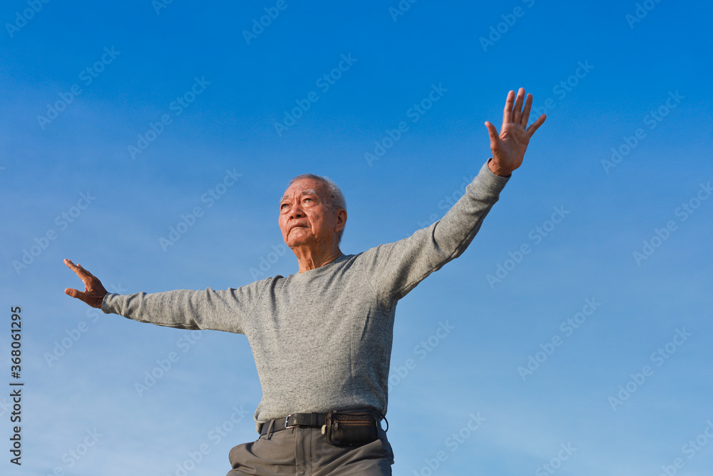 Asian Senior old man practice Taichi Chinese Kungfu on the beach Asian Senior old man practice Taichi Chinese Kungfu on the beach