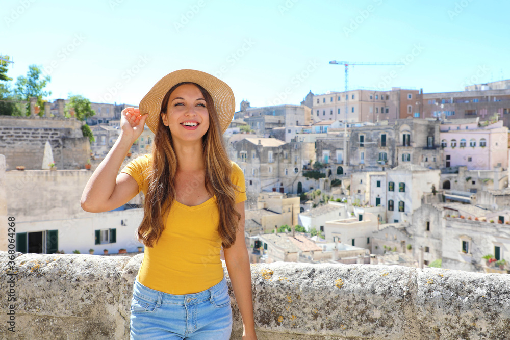 Happy cheerful tourist girl visiting the Sassi di Matera, Italy