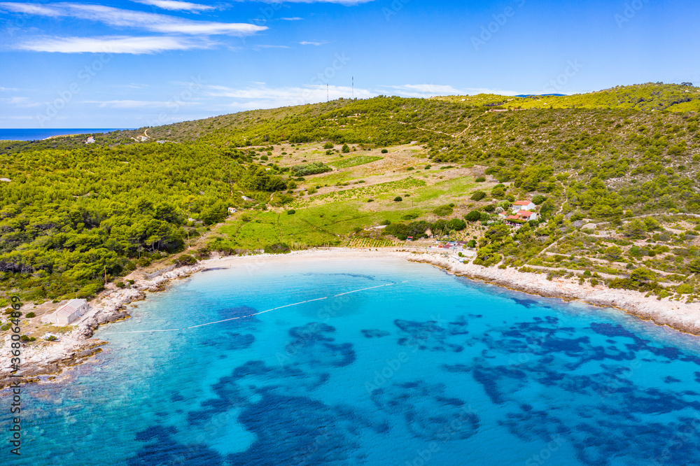 View of beautiful bay with blue turqoiuse sea on Mediterranean coast. Sailing destination. Summer vacation nackground with copy space. Vis island, Milna bay, Zaglav sandy beach. Seascape, cloudy sky