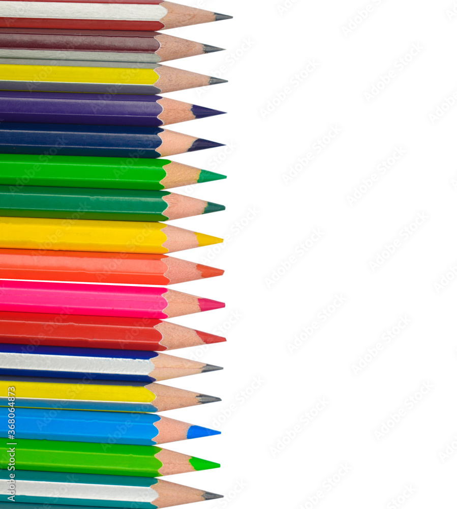 One line of different colored wood pencil crayons placed on a white background One line of different colored wood pencil crayons placed on a white background