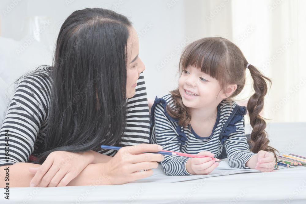Happy loving family mother and her daughter child girl play in children room. Funny mom and lovely child having fun together.Photo design for family, children and happy people concept