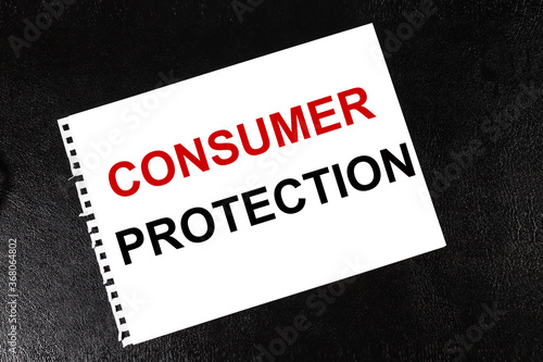 CONSUMER PROTECTION, TEXT ON A WHITE sheet of paper against a black background. business concept
