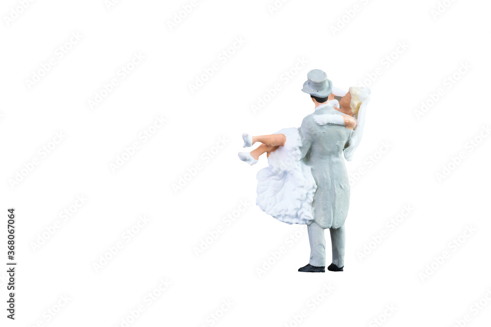 Close up of Miniature people wedding bride and groom couple isolated with clipping path on white background.Elegant Design with copy space for placement your text, mock up for love and wedding concept Close up of Miniature people wedding bride and groom couple isolated with clipping path on white background.Elegant Design with copy space for placement your text, mock up for love and wedding concept