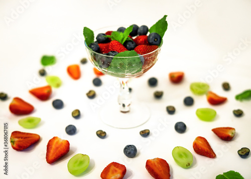 berry cocktail in a crystal glass with strawberries, blueberries, blueberries and mint close up  