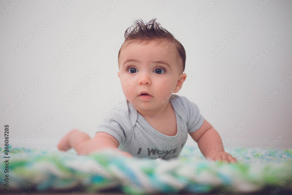 Baby crawling and playing on blanket Baby crawling and playing on blanket