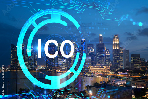 Initial coin offering hologram, night panorama city view of Singapore, the center of cryptocurrency projects in Asia. The concept of widespread ICO hysteria. Double exposure.