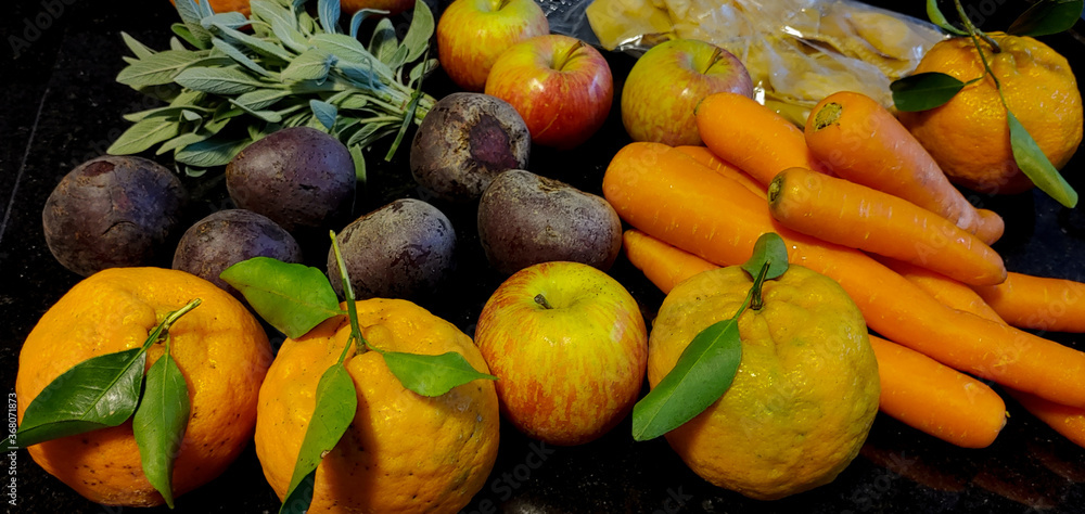 A small variety of fruits and vegetables that have just arrived from the organic fair.