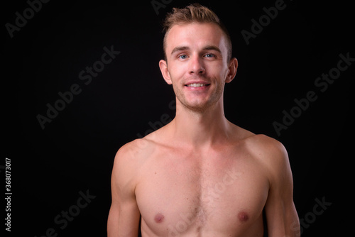 Portrait of young handsome shirtless man with blond hair
