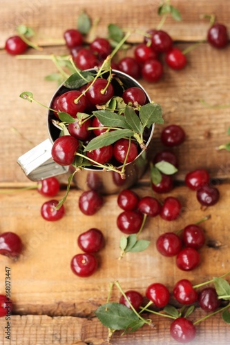 Ripe red cherries in an iron cup