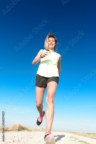 Girl running under the blue sky