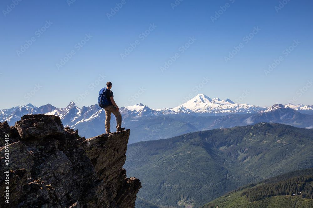Adventurous Person Hiking in the Canadian Mountains during a sunny summer morning. Taken on the Trail to Cheam Peak in Chilliwack, East of Vancouver, British Columbia, Canada. Adventurous Person Hiking in the Canadian Mountains during a sunny summer morning. Taken on the Trail to Cheam Peak in Chilliwack, East of Vancouver, British Columbia, Canada.
