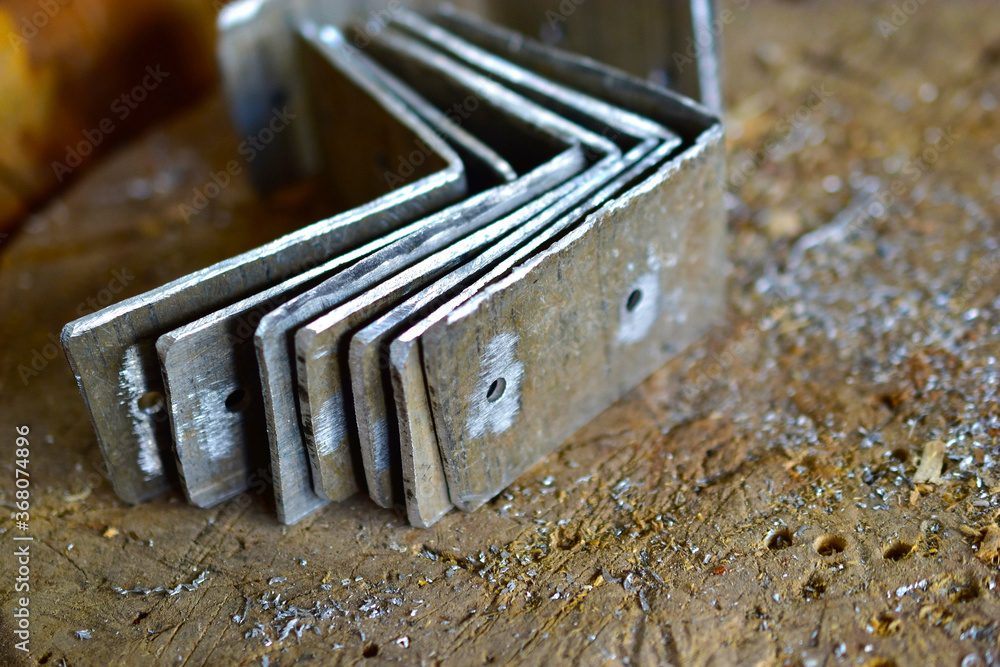 Metal corners for construction with holes on the table Metal corners for construction with holes on the table