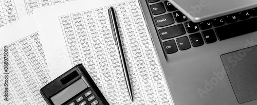 Top view of working space with financial reports, laptop, calculator and pen. Top view. Business planning concept on white.