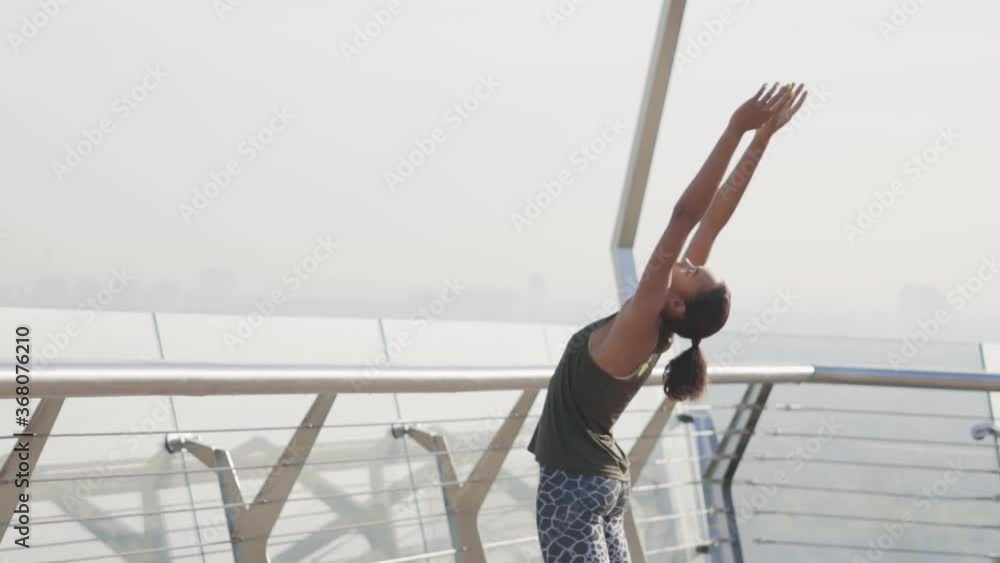 slow motion.stretching outside. A young African girl does exercises for the back. girl doing back tilts FullHD slow motion.stretching outside. A young African girl does exercises for the back. girl doing back tilts FullHD
