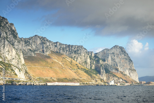 Rocky shores (cliffs, mountains) of the Europa Point, a view from the sailing boat. Gibraltar, British Overseas Territory. Travel destinations, national landmark, sightseeing theme