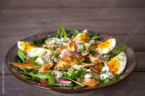 Smocked mackerel fish salad with eggs  arugula and vegetables. horizontal photo