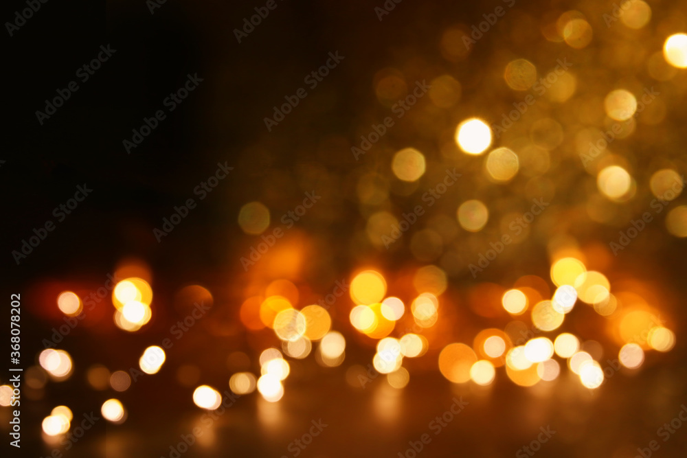 background of abstract gold and black glitter lights. defocused background of abstract gold and black glitter lights. defocused