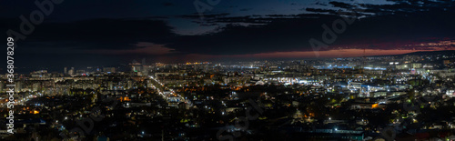 Panorama of multi-colored  blue and orange colors  sunset on the city of Saratov. View from the observation deck to the night city. Panorama of the night city