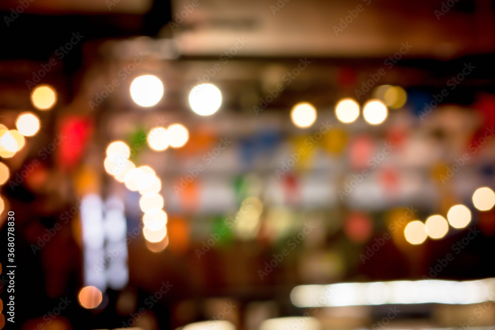 Blur the lights on the restaurant. Blurred cafe background with bokeh. orange ,red, light, blue, green, pink. Blur the lights on the restaurant. Blurred cafe background with bokeh. orange ,red, light, blue, green, pink.